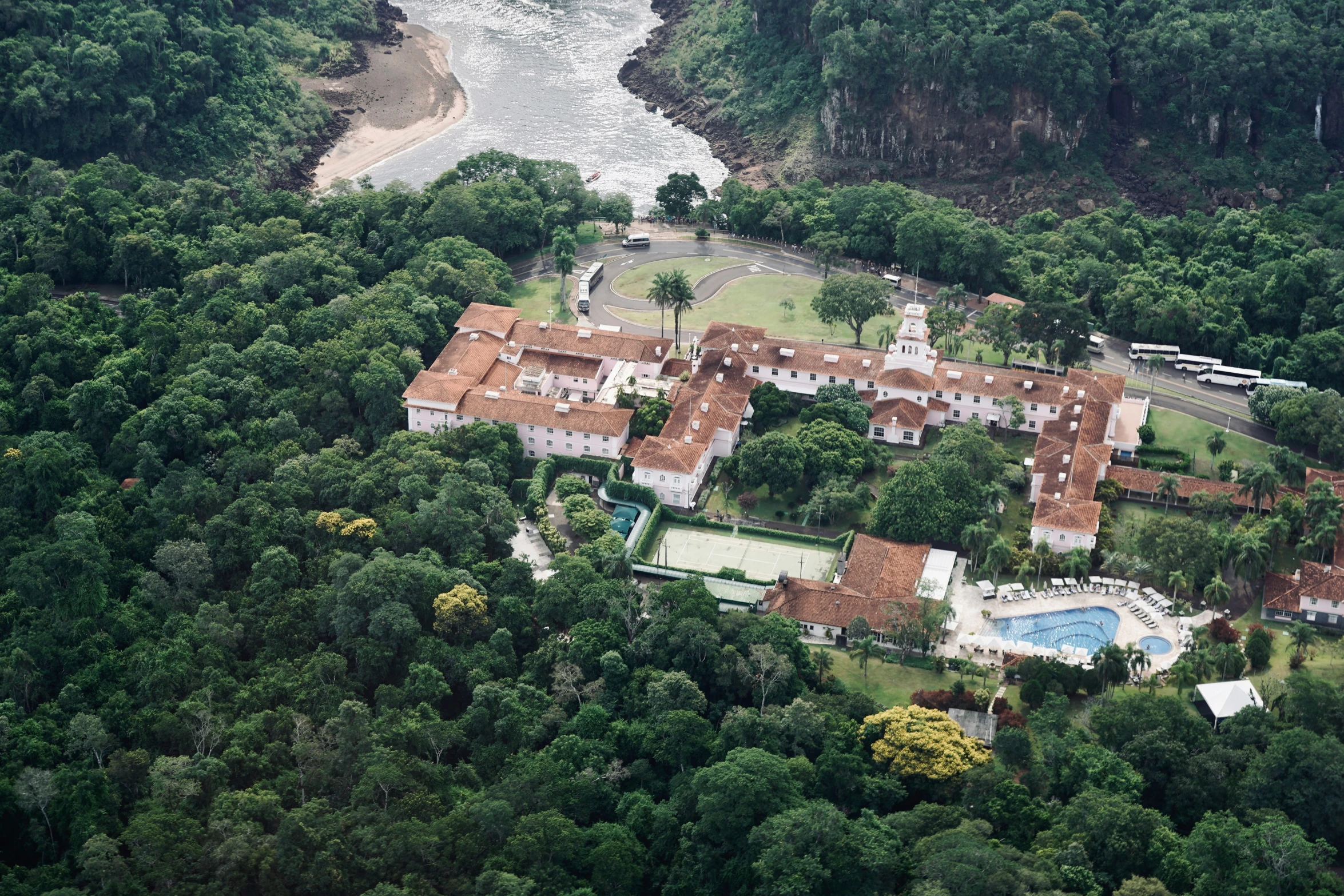 this estate sits at the base of a hill in a wooded area