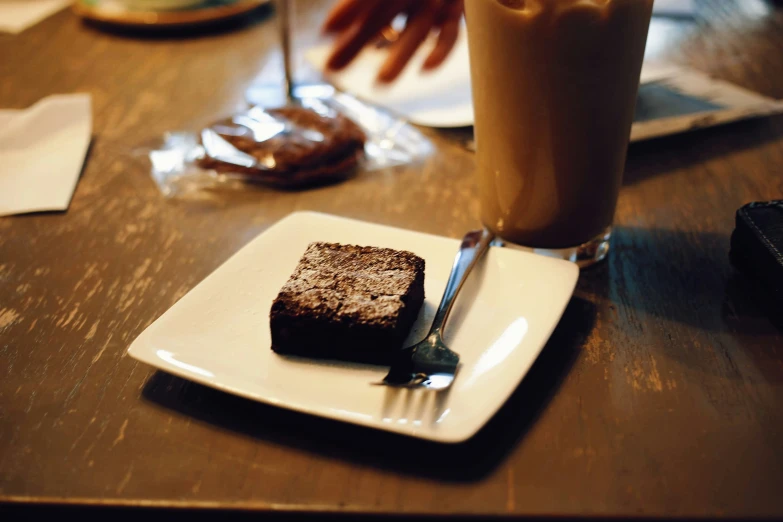 a square plate with some cake on it