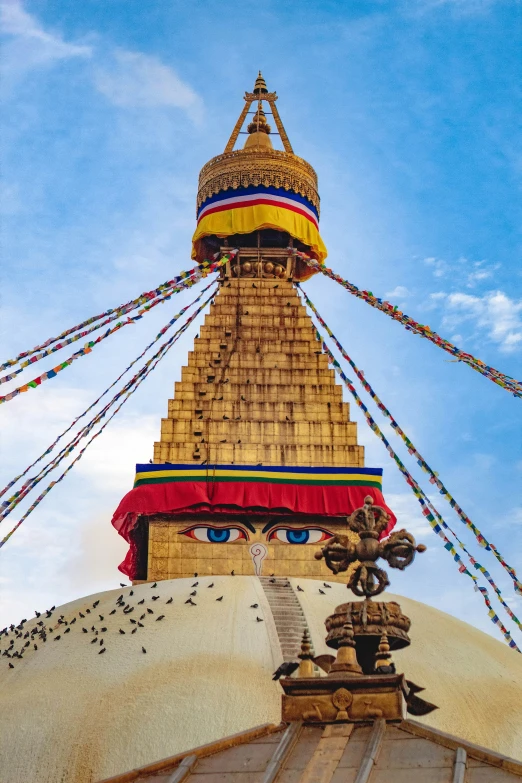 an artistic view of an outside structure with lots of colorful streamers