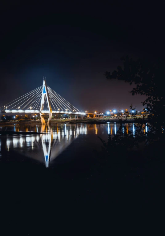 the beautiful bridge is lit up at night