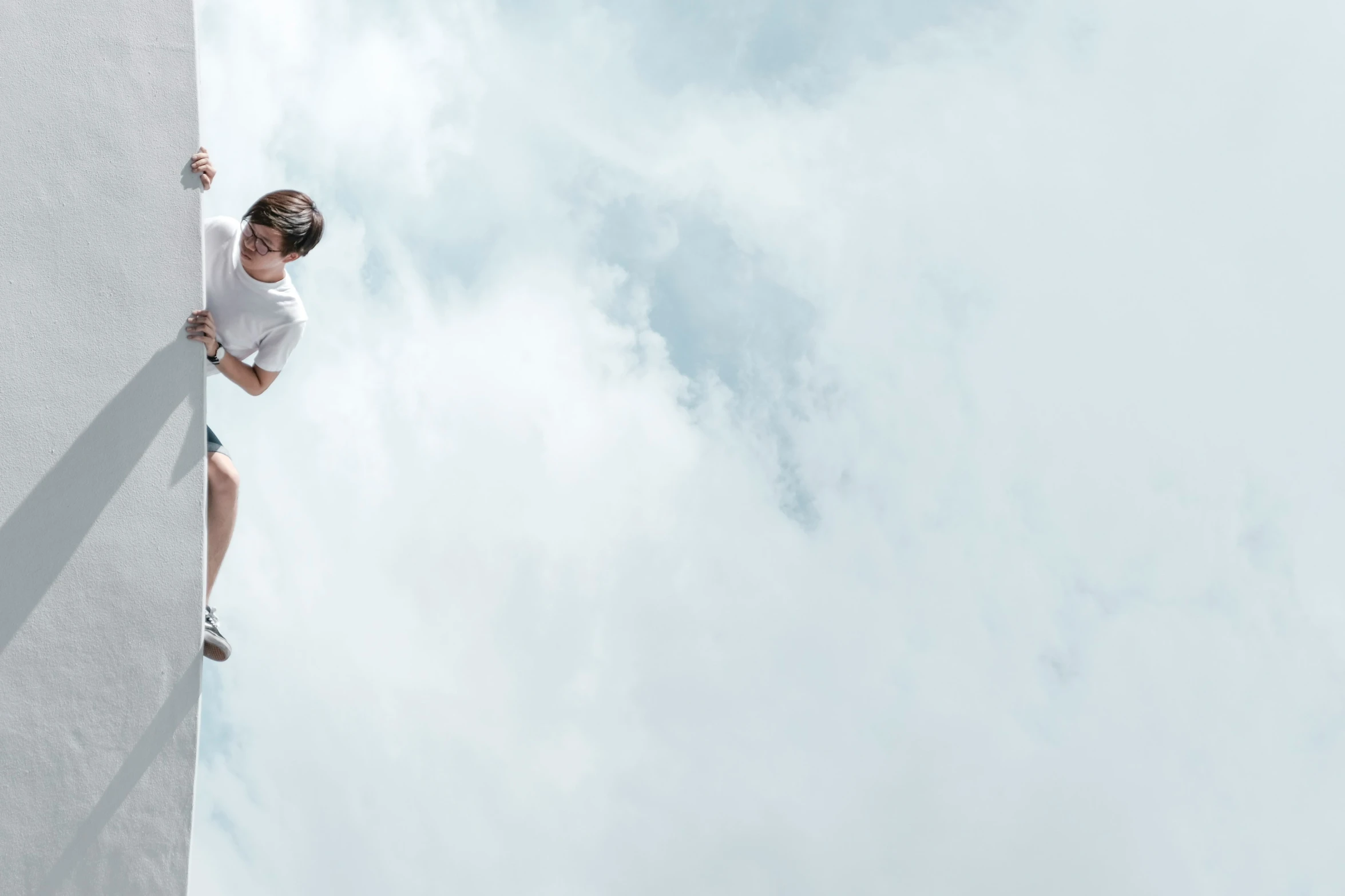 a man climbing on top of a large block