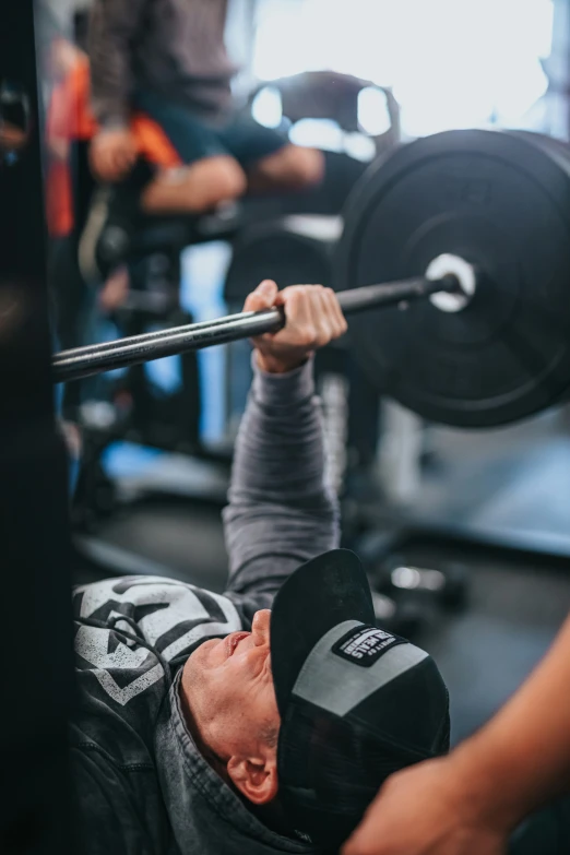 a person is lifting the barbell for a position