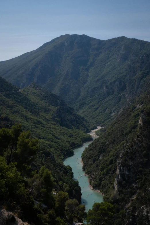 a valley that is surrounded by mountains with a river