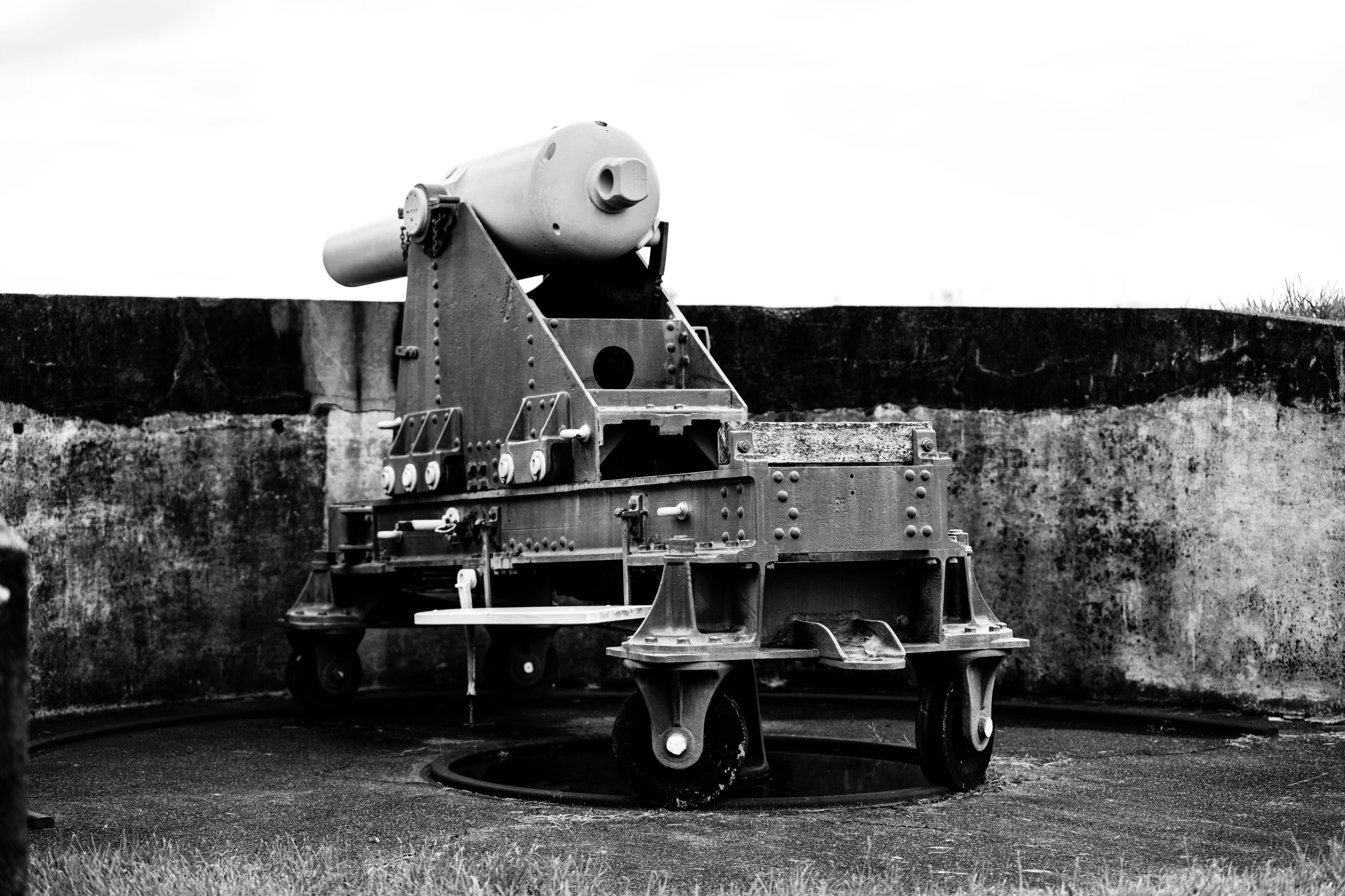 a large concrete object with a few benches beside it