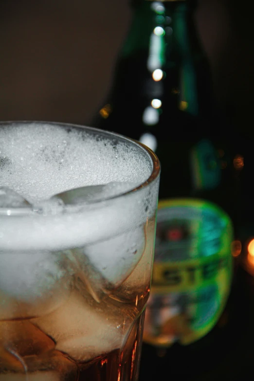 a close up of a drink with ice cubes in a glass