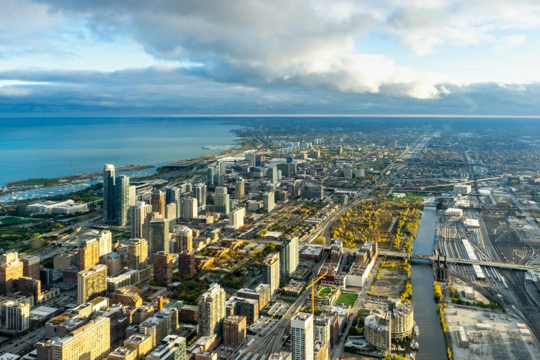 a very large city with tall buildings next to a large body of water