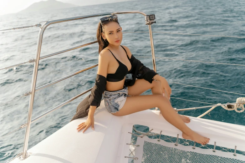 a beautiful woman sitting on the front of a boat