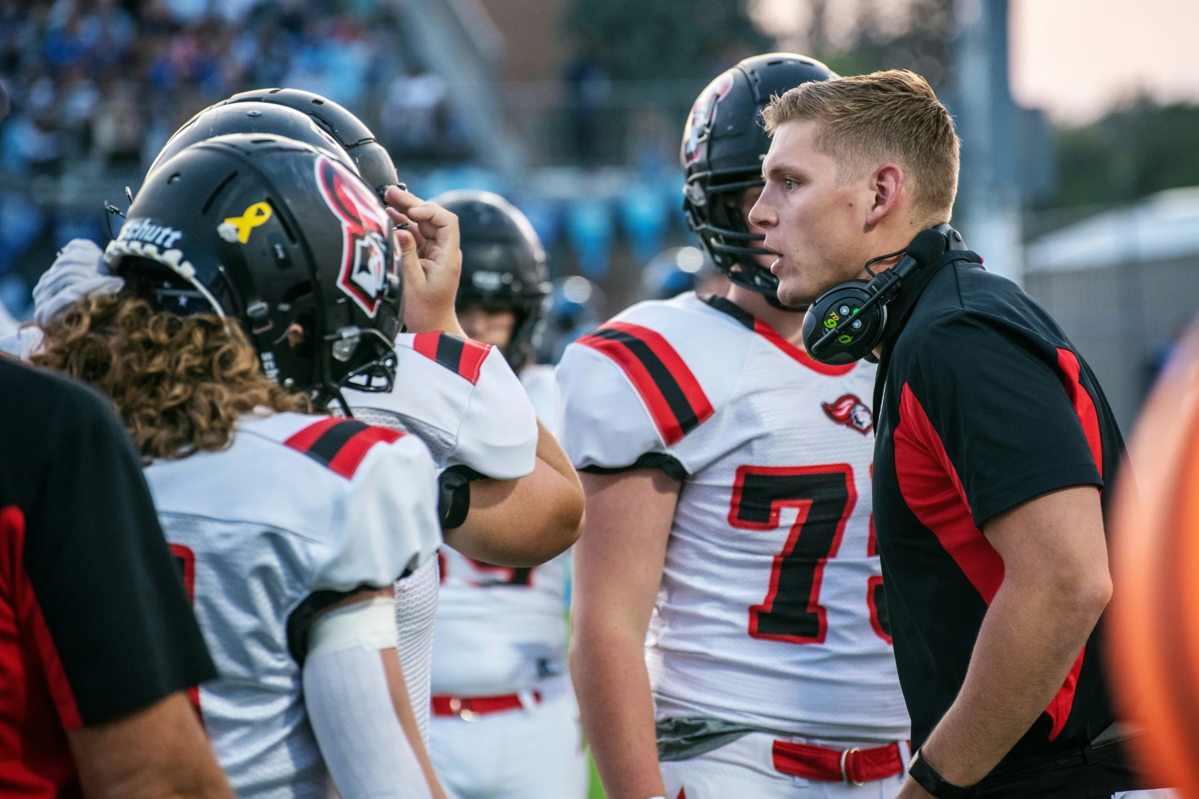 a football player with his team on the sideline