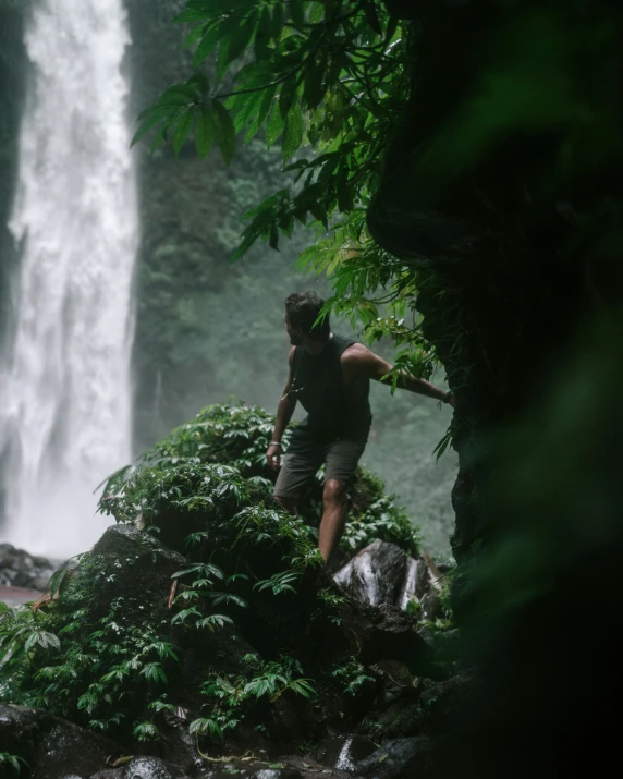 a man standing on the edge of a waterfall