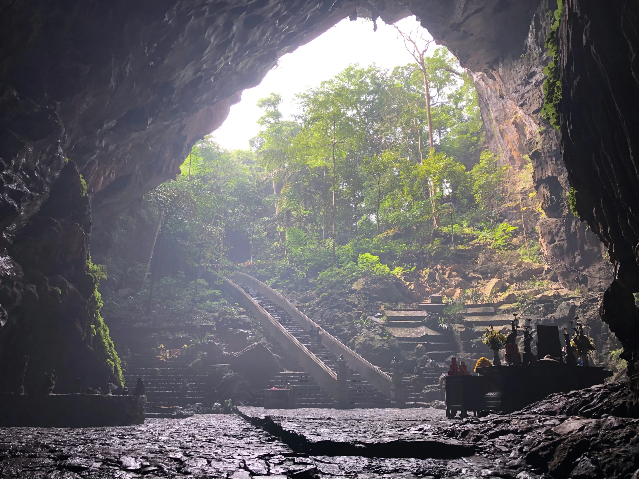 there is an arch in the cave with stairs coming out