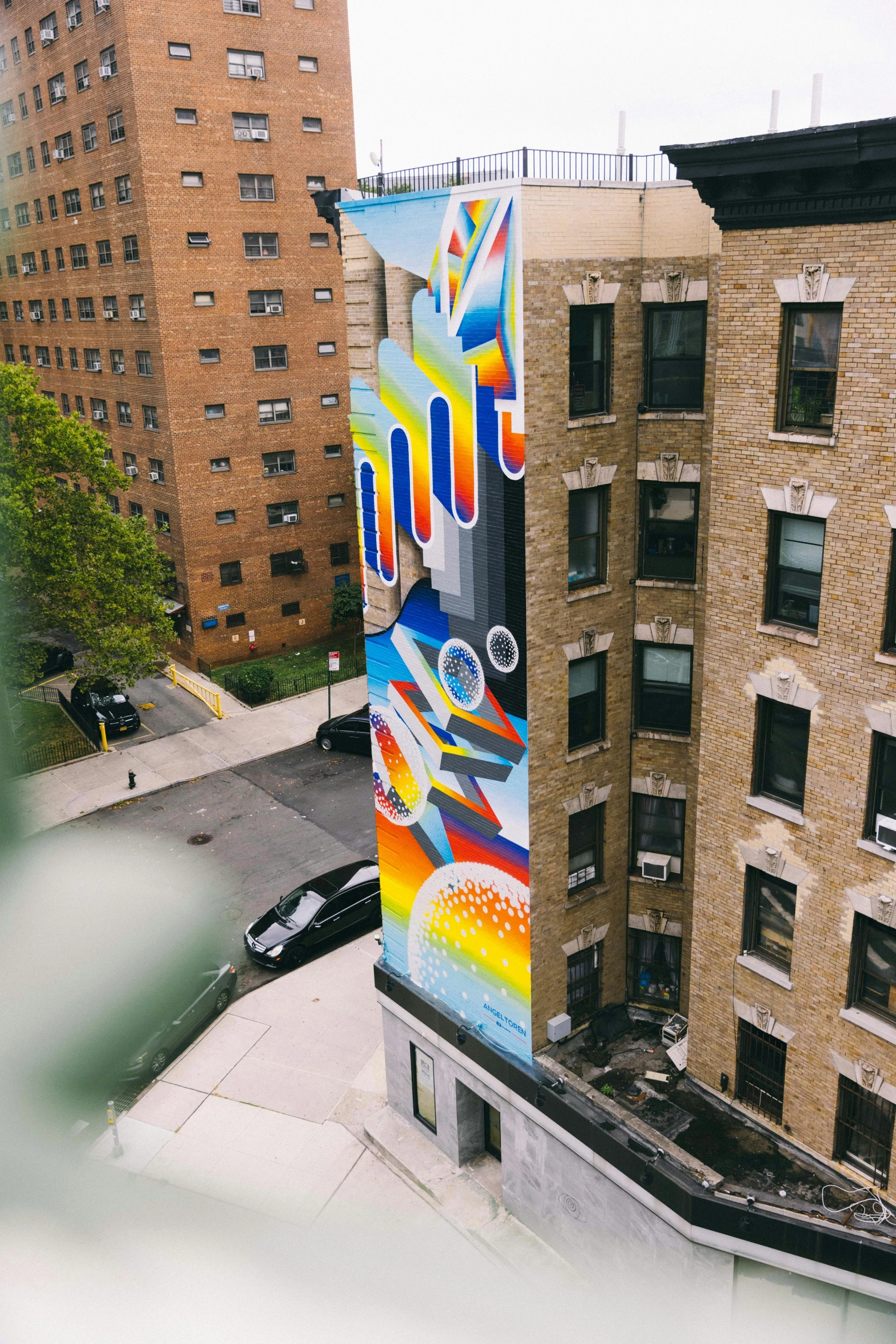 a group of buildings with a colorful mural on the side