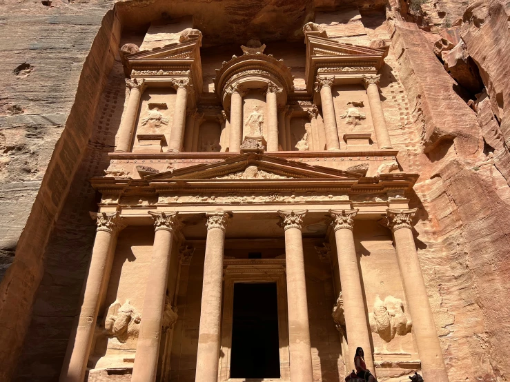 people stand at a stone doorway that appears to be inside a building