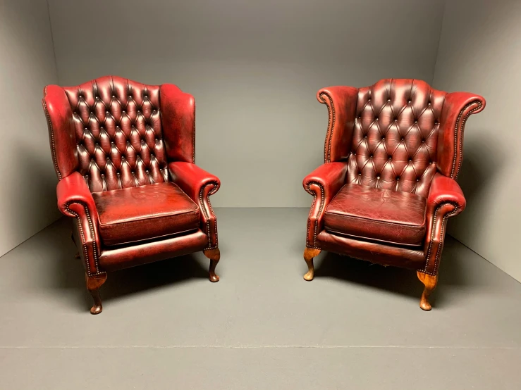 a pair of red vintage leather lounge chairs