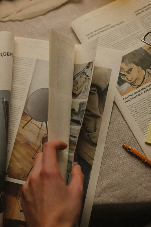 a person is reading a book while surrounded by other papers