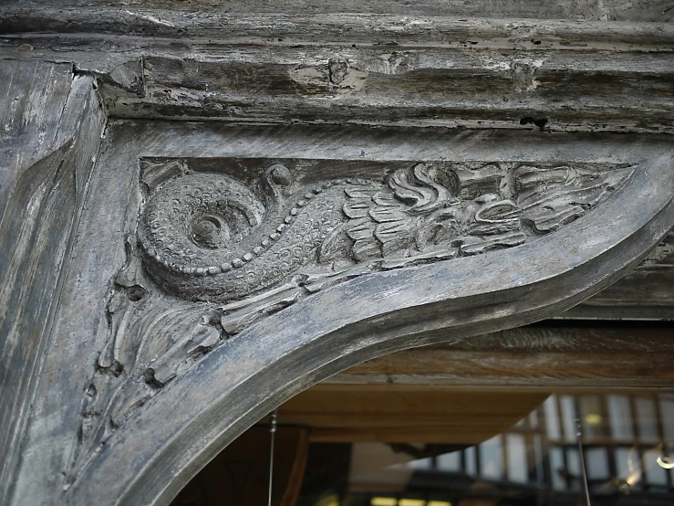 a grey stone sculpture with carvings on it