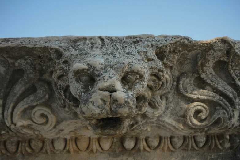 a lion's head in some type of stone