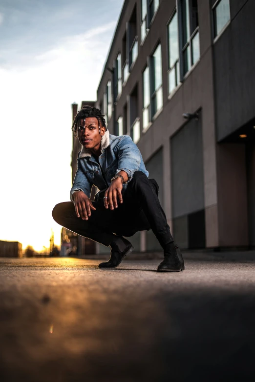 the skateboarder is crouched down in front of a building