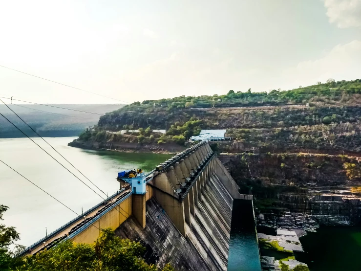 a large wall next to the water and power lines