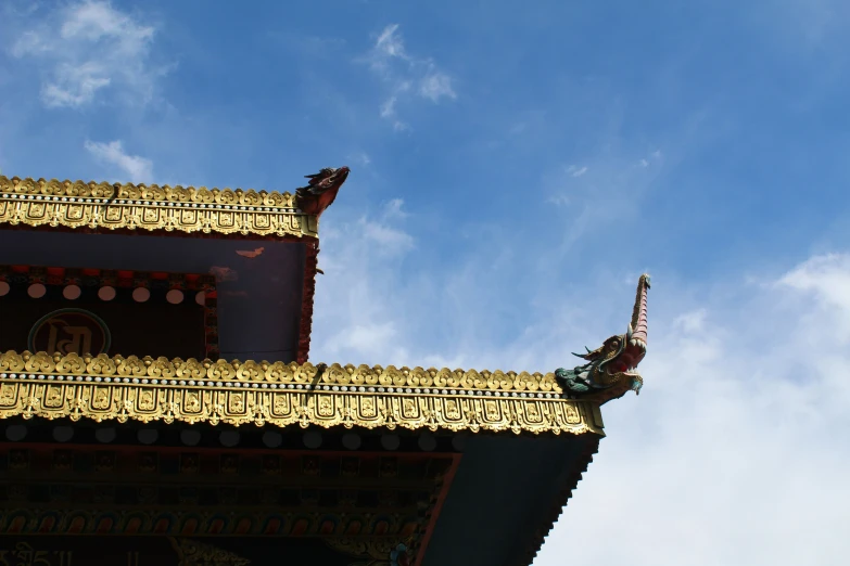 an ornate gold architecture with a large bird on top