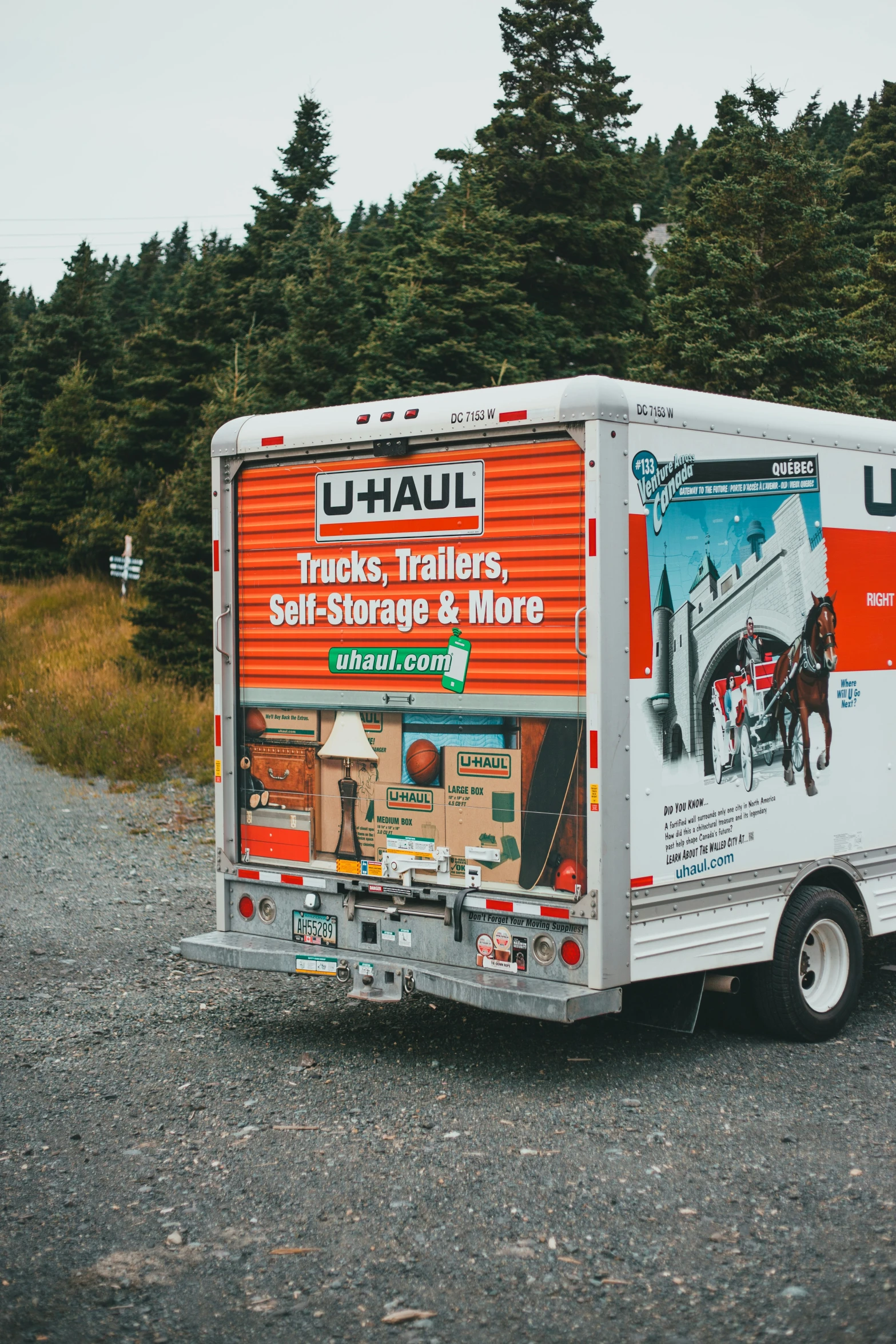 a truck is parked along a gravel road