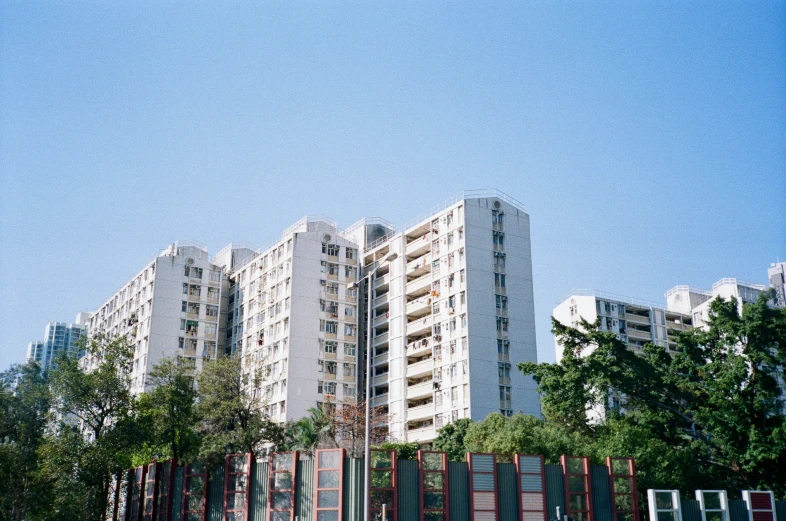 an apartment building with lots of trees around it