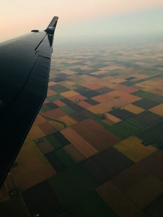 view of an airplane wing over the grass