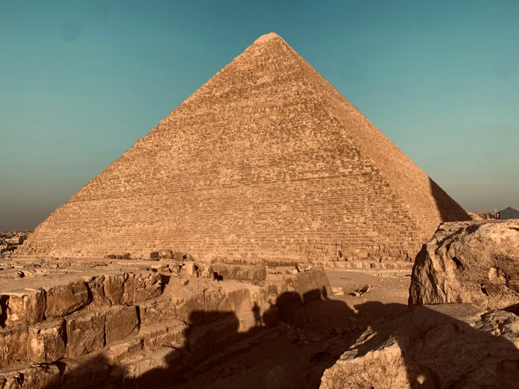 a large pyramid in the desert is standing alone