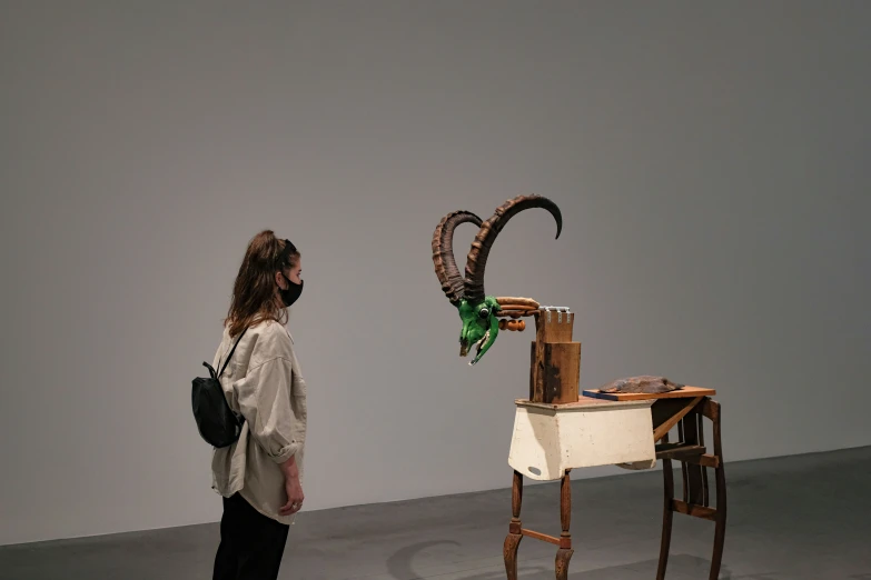 a woman looking at artwork on the wall