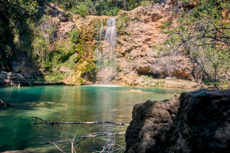 a big waterfall in the middle of the forest