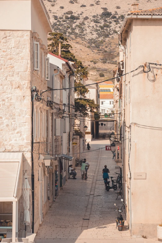 an old, narrow street is lined with shops