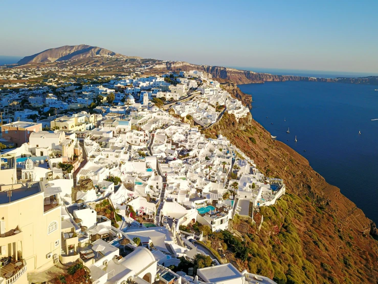 a hill side town overlooks the ocean