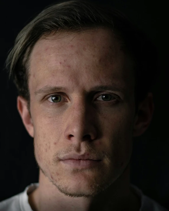 a man in white shirt posing for a picture