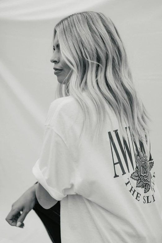 a blonde girl with long hair is holding a skateboard