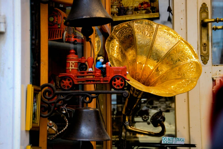 a gold colored musical instrument sitting on top of a metal object