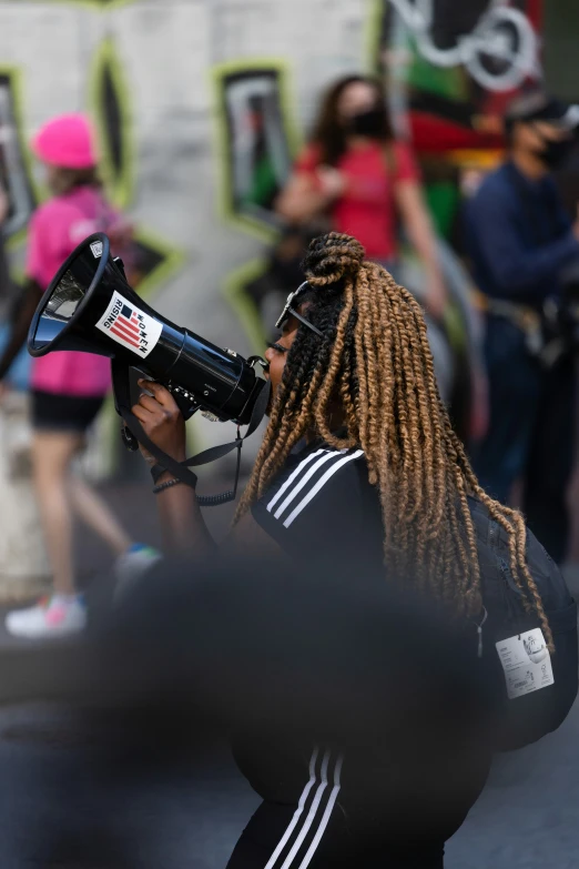 a woman with dreadlocks and a megaphone