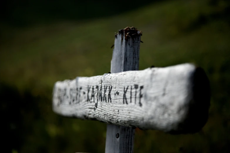 a sign warning about hikes on a grassy hill