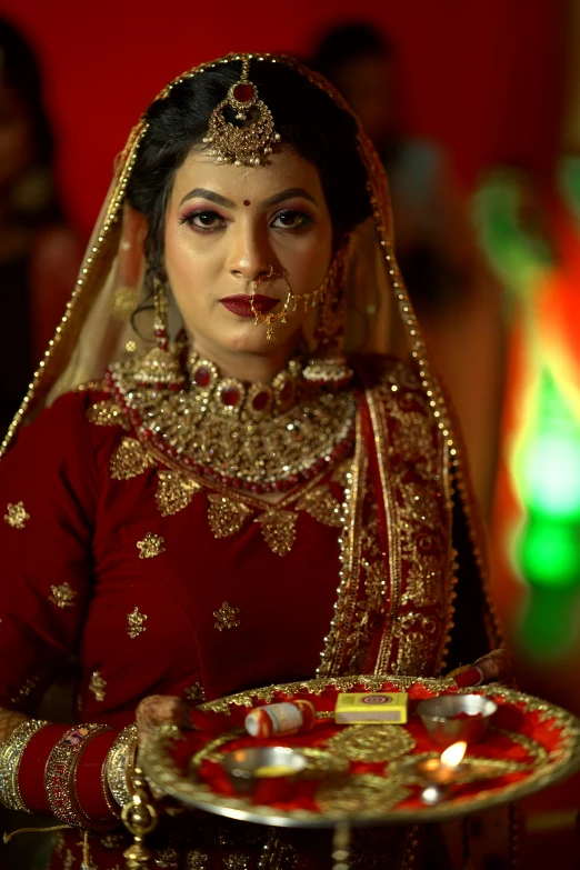 a woman with a golden and red outfit holding a plate