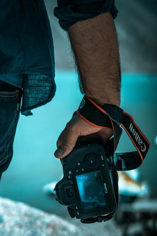 a person holding a camera with their right hand