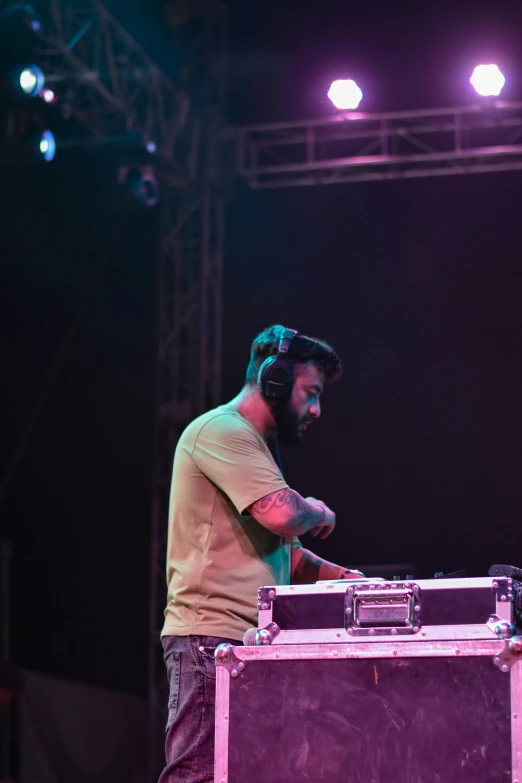 a man is standing in front of a sound mixer