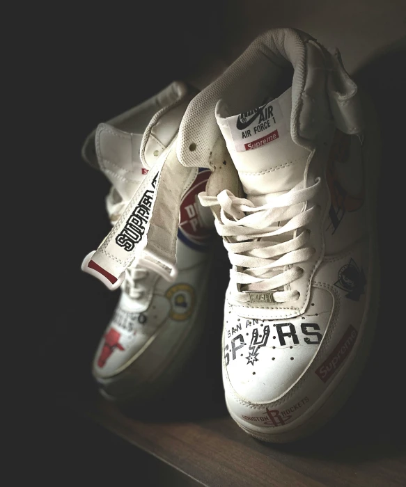 two pairs of shoes with stickers on them