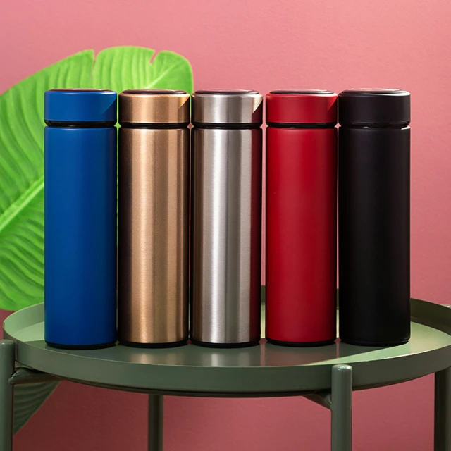 four stainless steel coffee cups sitting next to each other