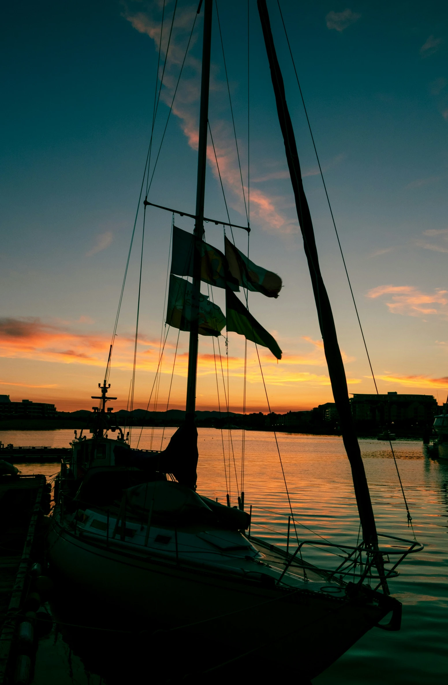 a boat sailing in the water at sunset