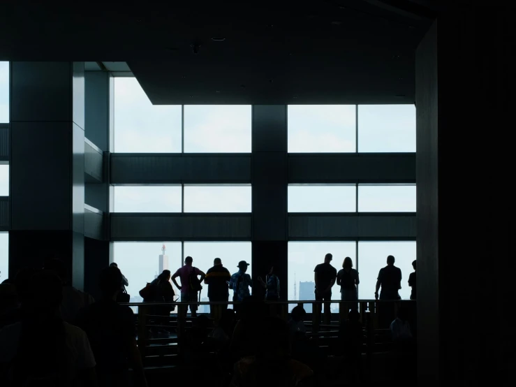 some people standing in front of an open window