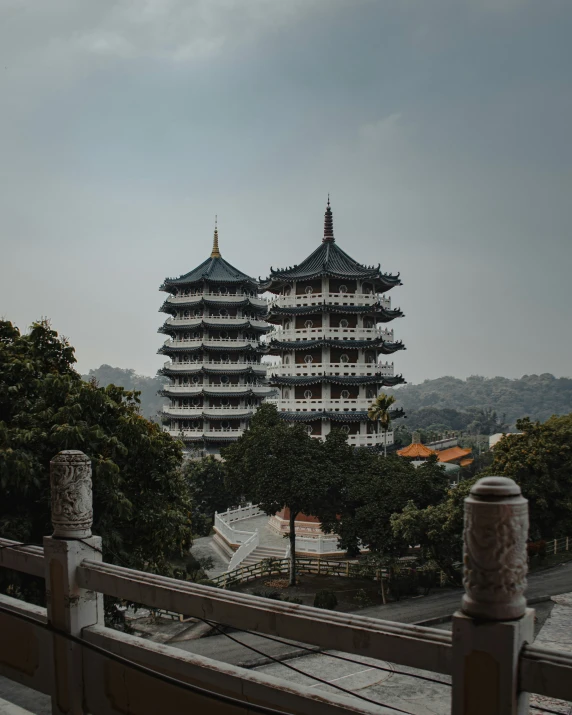 tall buildings on the top of hill next to trees