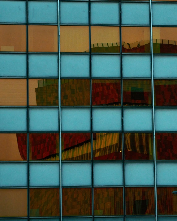 the reflection of a building across a mirrored window