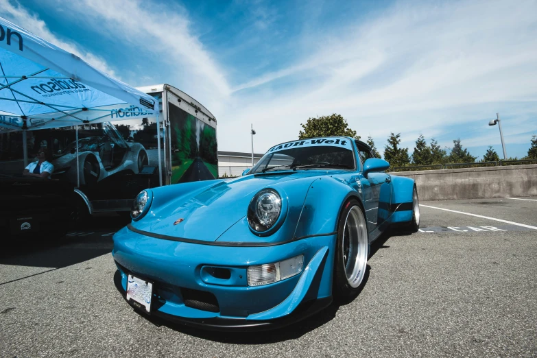 a blue sports car parked on the side of a road