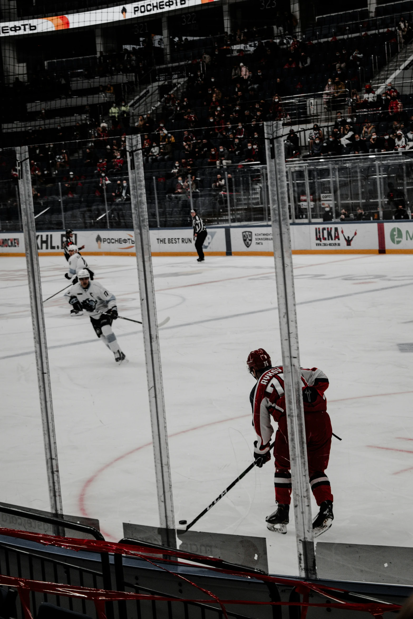 hockey players play hockey in an arena with fans