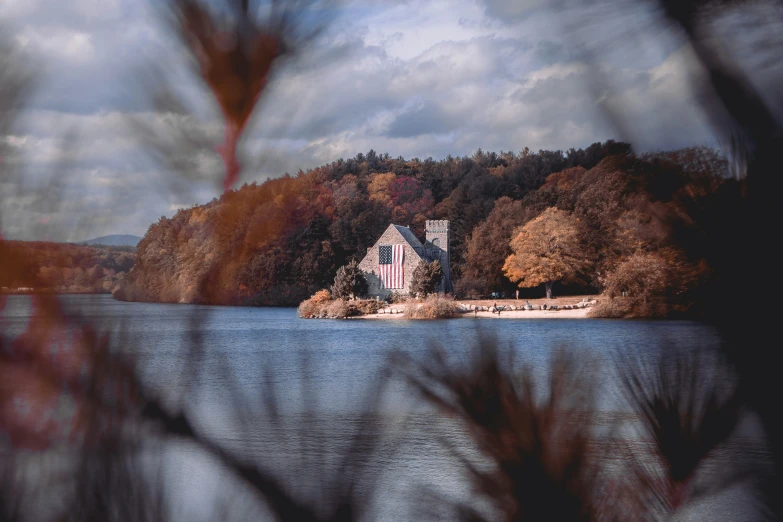 a house sits on a small island out across from the water