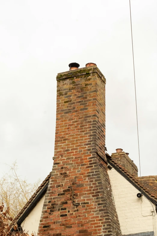 a brick building with a chimney and roof top