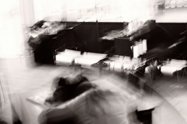 blurry po of a person sitting at desks